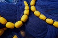 Yellow floats with piled fishing nets Royalty Free Stock Photo