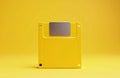 Yellow floppy disk on yellow background shows retro tech. Vintage diskette for old data. Obsolete computer drive media reminds Royalty Free Stock Photo