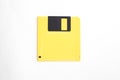 Yellow floppy disk on white background