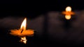 Yellow Flower Candle burning floating in water Royalty Free Stock Photo