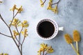 Yellow flowers kangaroo legs on marbled background and white coffee cup