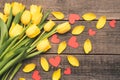 Yellow flowers seen from above. Lay flat on boards. Tulip petals and red hearts. Royalty Free Stock Photo