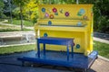 Yellow flowery public piano in park