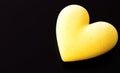 Yellow fluffy heart on a black background