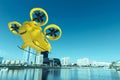 Yellow flying taxi against the sky, city electric transport drone. Car with propellers, clean air, fast ride. Mixed media, copy