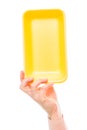 Yellow foam polystyrene packaging in female hand on a white