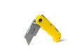 Yellow folding knife for cutting insulated on a white background Royalty Free Stock Photo