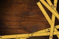 Yellow folding wooden rulers on a work table with copy space