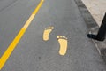 Yellow foot symbol for walk path on road Royalty Free Stock Photo