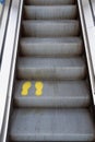 Yellow footprint on empty escalators