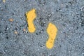 Yellow footprint signs on the floor for pedestrian. Symbol of walkway