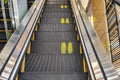 Yellow footprint symbol for social distancing on steps of escalator during Corona virus, social distancing and new normal concept