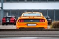 Yellow Ford Mustang in the parking lot. Powerful fast sports car.