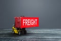 Yellow forklift carries red freight container. Transportation logistics infrastructure, import and export of goods and products Royalty Free Stock Photo