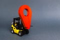 Yellow forklift carries a red location pointer. Transportation services and logistics management in production warehouse