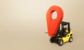 Yellow forklift carries a red location pointer. Transportation services and logistics management warehouse. Destination cargo