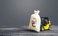 Yellow forklift carries a Ukrainian hryvnia UAH money bag. Big contract, profitable deposit, take a loan. Payment of taxes. Royalty Free Stock Photo