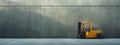 A yellow forklift is parked by a concrete wall in a warehouse Royalty Free Stock Photo