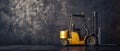 Yellow forklift is parked in front of a wall Royalty Free Stock Photo