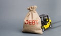 Yellow forklift truck can not lift the bag with the inscription debt. Inability to repay a loan, debt restructuring. High business Royalty Free Stock Photo