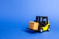 Yellow Forklift truck with cardboard box. Increase sales, production of goods. transportation, storage of cargo. Freight shipping