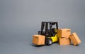 Yellow Forklift truck with cardboard boxes. Increase sales, production of goods. transportation, storage of cargo and goods Royalty Free Stock Photo