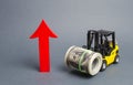 Yellow Forklift truck carries a big bundle of dollars and red arrow up. Economic reforms, emerging markets. Growth of income Royalty Free Stock Photo