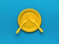 Yellow forks and a spoon in a yellow plastic bowl on a blue background. Flat lay Royalty Free Stock Photo
