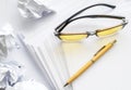 Yellow fountain pen and yellow glasses on a sheet of white paper Royalty Free Stock Photo