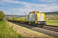 Yellow freight train on the railway with a field in the background during the daytime, Retzbach