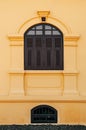 Yellow French Colonial building facade and artisan window frame of Udon Thani city museum, Thailand Royalty Free Stock Photo