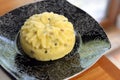 Yellow and fresh artisan cheese with seeds on a plate