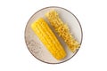 Yellow fresh boiled sweet corn cob and core on vintage plate isolated on white background Royalty Free Stock Photo