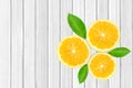 yellow fresh lemon fruit slices with green leaves on the white wooden table Royalty Free Stock Photo