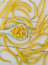 Yellow fresh wax bean on white woodern boards. Top view Royalty Free Stock Photo