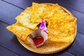 Yellow fried dumplings and a cup of sauce on a bamboo dish at decorated with orchid placed on the table dark wood Royalty Free Stock Photo
