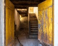 Yellow front door in an old dilapidated house