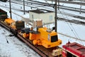 The yellow and front loader disassembled into parts is loaded onto a cargo railway platform. Royalty Free Stock Photo