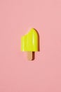 Yellow frozen juice on a stick on a red background