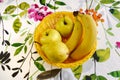 Yellow fruit inside the basket on the kitchen table Royalty Free Stock Photo