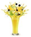 Yellow fruit juice splash. Whole and sliced apple, mango, kiwi and blackberry in a sweet yellow juice or cocktail with splashes