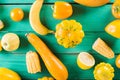 Yellow fruits and vegetables on a turquoise wooden background. Colorful festive still life. Copyspace. Yellow squash, melon, lemon Royalty Free Stock Photo