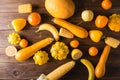 Yellow fruits and vegetables on a wooden background. Colorful festive still life. Royalty Free Stock Photo