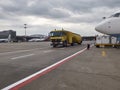 Yellow fuel tank car and planes on the airfield Royalty Free Stock Photo