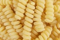 Yellow fusilli pasta background texture. Delicious pasta or fusilli noodles. Italian raw noodles. Homemade dry noodles. Spaghetti Royalty Free Stock Photo