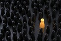 Yellow game pawn among dark ones. Standing out of crowd concept