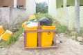 Yellow garbage can or dusbins served for recycled garbage in the village in Thailand Royalty Free Stock Photo