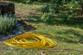 Yellow garden hose in a haunted garden Royalty Free Stock Photo