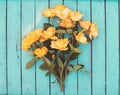 Yellow garden roses on rustic blue green wooden background. Vale Royalty Free Stock Photo