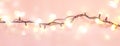 Yellow garland on a pink background. Holiday Christmas concept Royalty Free Stock Photo